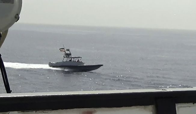 In this image from a video made available by the U.S. Navy, a boat of Iran&#x27;s Islamic Revolutionary Guard Corps Navy (IRGCN) operates in close proximity to patrol coastal ship USS Sirocco (PC 6) and expeditionary fast transport USNS Choctaw County (T-EPF 2) in the Strait of Hormuz, Monday, June 20, 2022. A U.S. Navy warship fired a warning flare to wave off an Iranian Revolutionary Guard speedboat coming straight at it during a tense encounter in the strategic Strait of Hormuz, officials said Tuesday. (U.S. Navy via AP)