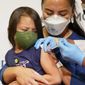 Maria Assisi holds her daughter Mia, 4 as Registered Nurse Margie Rodriguez administers the first dose of the Moderna COVID-19 vaccine for children 6 months through 5 years old, Tuesday, June 21, 2022, at Montefiore Medical Group in the Bronx borough of New York. (AP Photo/Mary Altaffer)