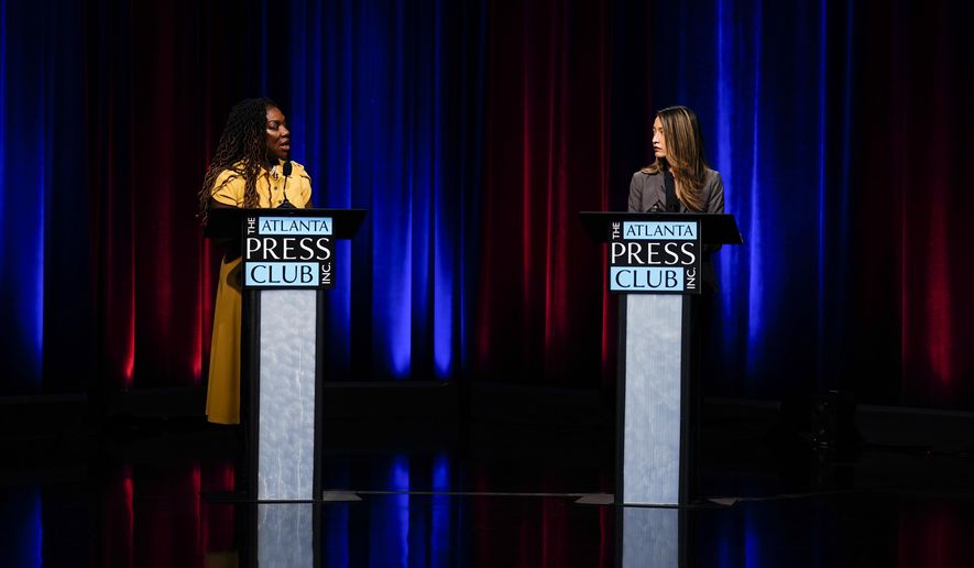 Former state Rep. Dee Dawkins-Haigler, left, and Georgia State Rep. Bee Nguyen, right, participate in Georgia&#39;s secretary of state democratic primary election runoff debates on Monday, June 6, 2022, in Atlanta. (AP Photo/Brynn Anderson)