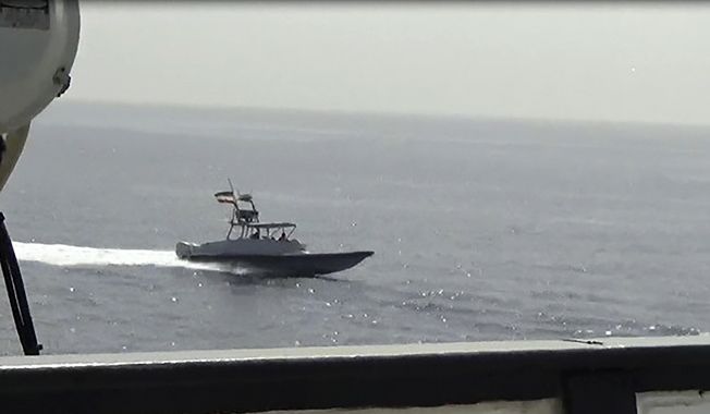 In this image from a video made available by the U.S. Navy, a boat of Iran&#x27;s Islamic Revolutionary Guard Corps Navy (IRGCN) operates in close proximity to patrol coastal ship USS Sirocco (PC 6) and expeditionary fast transport USNS Choctaw County (T-EPF 2) in the Strait of Hormuz, Monday, June 20, 2022. A U.S. Navy warship fired a warning flare to wave off an Iranian Revolutionary Guard speedboat coming straight at it during a tense encounter in the strategic Strait of Hormuz, officials said Tuesday. (U.S. Navy via AP)