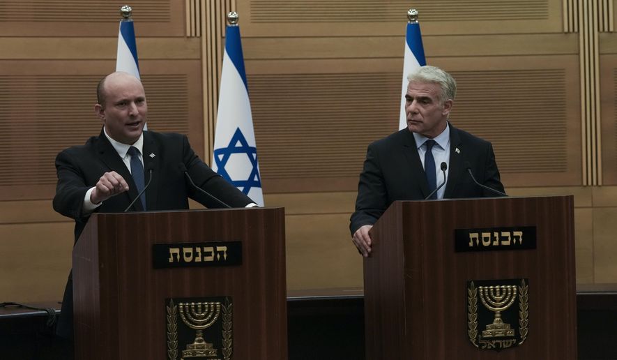 Israeli Prime Minister Naftali Bennett, left, speaks during a joint statement with Foreign Minister Yair Lapid, at the Knesset, Israel&#39;s parliament, in Jerusalem, Monday, June 20, 2022. Bennett&#39;s office announced Monday, that his weakened coalition will be disbanded and the country will head to new elections. Bennett and his main coalition partner, Yair Lapid, decided to present a vote to dissolve parliament in the coming days, Bennett&#39;s office said. Lapid is then to serve as caretaker prime minister. The election, expected in the fall, would be Israel&#39;s fifth in three years. (AP Photo/Maya Alleruzzo)