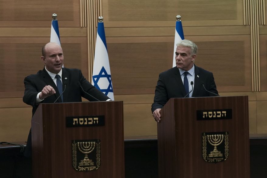 Israeli Prime Minister Naftali Bennett, left, speaks during a joint statement with Foreign Minister Yair Lapid, at the Knesset, Israel&#x27;s parliament, in Jerusalem, Monday, June 20, 2022. Bennett&#x27;s office announced Monday, that his weakened coalition will be disbanded and the country will head to new elections. Bennett and his main coalition partner, Yair Lapid, decided to present a vote to dissolve parliament in the coming days, Bennett&#x27;s office said. Lapid is then to serve as caretaker prime minister. The election, expected in the fall, would be Israel&#x27;s fifth in three years. (AP Photo/Maya Alleruzzo)
