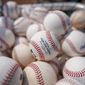 Baseballs are held in a basket on the field before a baseball game between the Cincinnati Reds and the Milwaukee Brewers in Cincinnati, Sunday, July 18, 2021. (AP Photo/Bryan Woolston, File) **FILE**