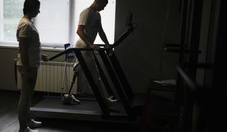 &amp;quot;Buffalo,&amp;quot; the name he uses as a soldier, walks in a treadmill at a clinic in Kyiv, Ukraine, Friday, June 17, 2022. &amp;quot;Buffalo&amp;quot; was at the Azovstal plant, in an underground bunker-turned-medical station that provided shelter from death and destruction above. He was among those in the list for evacuation after being shredded by mortar rounds, losing his left leg above the knee. (AP Photo/Natacha Pisarenko)