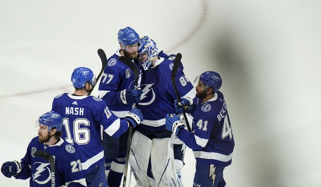Tampa Bay Lightning goaltender Andrei Vasilevskiy, center, celebrates with teammates after Game 3 of the NHL hockey Stanley Cup Final against Colorado Avalanche on Monday, June 20, 2022, in Tampa, Fla. (AP Photo/Chris O&#x27;Meara) **FILE**