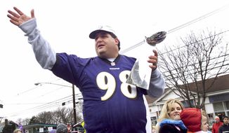 Tony Siragusa, defensive tackle for the Super Bowl-champion Baltimore Ravens, holds the Vince Lombardi trophy as he rides with his wife, Kathy, in a parade in his hometown of Kenilworth, N.J. on March 4, 2001. Siragusa, the charismatic defensive tackle who helped lead a stout Baltimore defense to a Super Bowl title, has died at age 55. Siragusa&#39;s broadcast agent, Jim Ornstein, confirmed the death Wednesday, June 22, 2022. (AP Photo/Jeff Zelevansky, File)