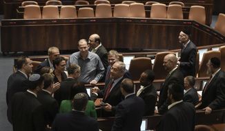 Former Israeli Prime Minister Benjamin Netanyahu receives congratulations from his Likud party members after a preliminary vote on a bill to dissolve parliament, at the Knesset, Israel&#39;s parliament, in Jerusalem, Wednesday, June 22, 2022. Israeli lawmakers voted in favor of dissolving parliament in a preliminary vote, setting the wheels in motion to send the country to its fifth national election in just over three years. (AP Photo/Maya Alleruzzo)