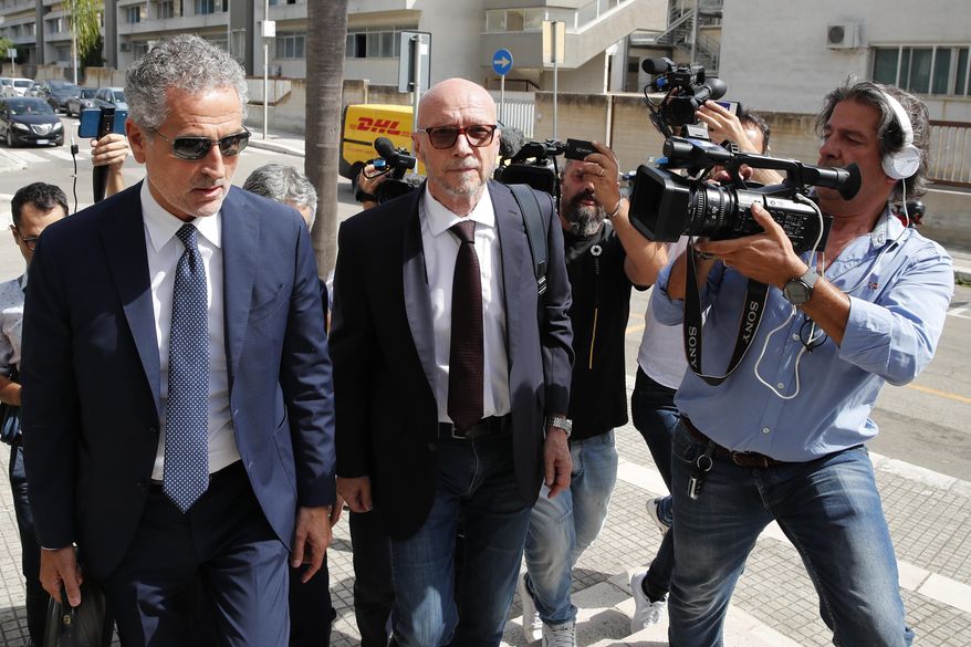 Canadian-born film director Paul Haggis, center, arrives with his lawyer Michele Laforgia at Brindisi law court in southern Italy, Wednesday, June 22, 2022, to be heard by prosecutors investigating a woman&#39;s allegations he had sex with her without her consent over the course of two days. Under Italian law, a judge, after hearing arguments from both prosecutors and defense lawyers, will rule on whether Haggis can be set free pending possible additional investigation. (AP Photo/Salvatore Laporta)