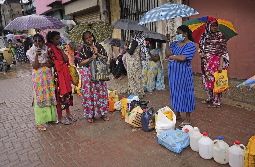 Women wait in a queue to buy kerosene in in Colombo, Sri Lanka, Saturday, June 11, 2022. Sri Lanka&#39;s economic crisis, the worst in its history, has completely recast the lives of the country&#39;s once galloping middle class. For many families that never had to think twice about fuel or food, the effects have been instant and painful, derailing years of progress toward lifestyles aspired to across South Asia. (AP Photo/Eranga Jayawardena)