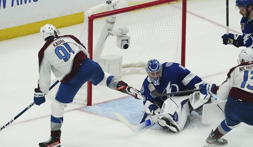 Colorado Avalanche center Nazem Kadri shoots the puck into the top of the goal past Tampa Bay Lightning goaltender Andrei Vasilevskiy (88) for a goal during overtime of Game 4 of the NHL hockey Stanley Cup Finals on Wednesday, June 22, 2022, in Tampa, Fla. (AP Photo/John Bazemore)