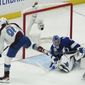 Colorado Avalanche center Nazem Kadri shoots the puck into the top of the goal past Tampa Bay Lightning goaltender Andrei Vasilevskiy (88) for a goal during overtime of Game 4 of the NHL hockey Stanley Cup Finals on Wednesday, June 22, 2022, in Tampa, Fla. (AP Photo/John Bazemore)