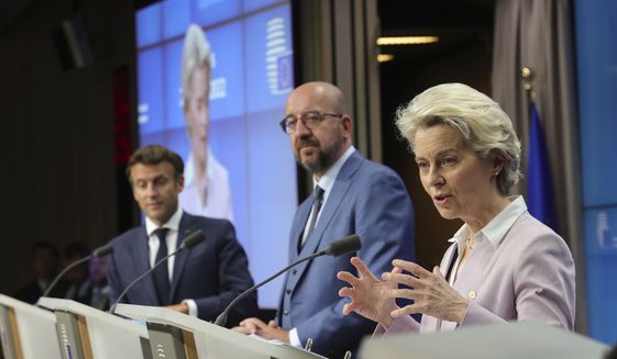From right, European Commission President Ursula von der Leyen, European Council President Charles Michel and French President Emmanuel Macron address a media conference at an EU summit in Brussels, Thursday, June 23, 2022. The European Union&#39;s leaders have agreed to make Ukraine a candidate for EU membership, setting in motion a potentially years long process that could draw the embattled country further away from Russia&#39;s influence and bind it more closely to the West. (AP Photo/Olivier Matthys)