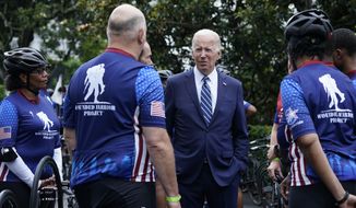 President Joe Biden talks with riders in the Wounded Warrior Project Soldier Ride at the White House in Washington, Thursday, June 23, 2022, following an event to welcome wounded warriors, their caregivers and families to the White House as part of the annual Soldier Ride to recognize the service, sacrifice, and recovery journey for wounded, ill, and injured service members and veterans. (AP Photo/Susan Walsh)