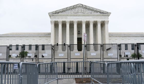 Anti-scaling fencing is seen outside the Supreme Court, Thursday, June 23, 2022, in Washington. (AP Photo/Jose Luis Magana)