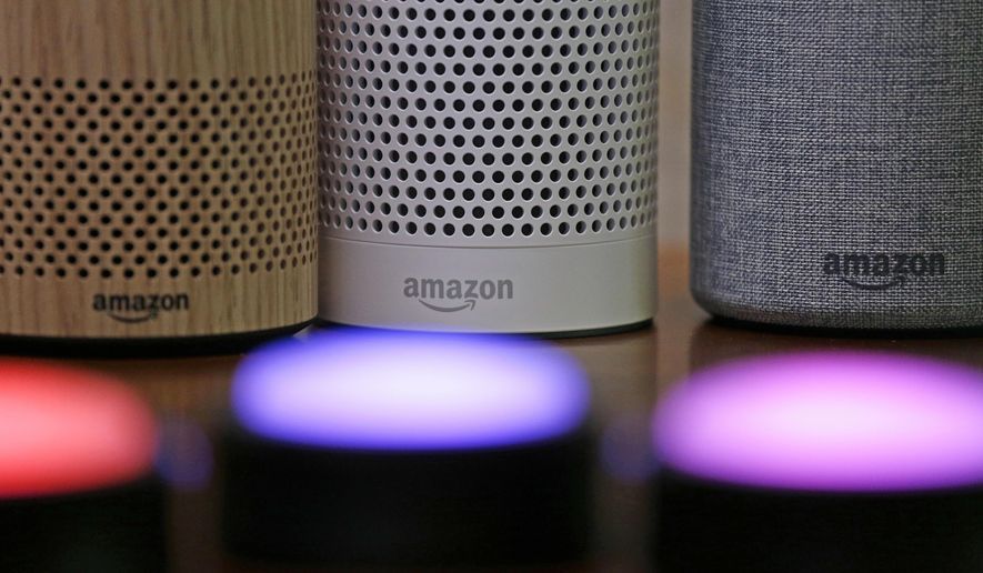 Amazon Echo and Echo Plus devices, behind, sit near illuminated Echo Button devices during an event by the company in Seattle on Sept. 27, 2017. Amazon’s Alexa might soon replicate the voice of family members - even if they’re dead. The capability, unveiled at Amazon’s Re:Mars conference in Las Vegas Wednesday, June 22, 2022, is in development and would allow the virtual assistant to mimic the voice of a specific person based on a less than a minute of provided recording. (AP Photo/Elaine Thompson, File)