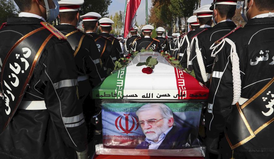 FILE - In this photo released by the official website of the Iranian Defense Ministry, military personnel stand near the flag-draped coffin of Mohsen Fakhrizadeh, a scientist who was killed on Friday, during a funeral ceremony in Tehran, Iran, Monday, Nov. 30, 2020. A court in Iran on Thursday, June 23, 2022 ordered the United States government to pay over $4 billion to the families of Iranian nuclear scientists who have been killed in targeted attacks in recent years, state-run media reported. (Iranian Defense Ministry via AP, File)