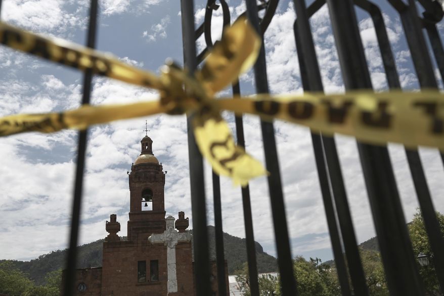 A police tape cordons off the crime scene in the church of Cerocahui, Mexico, Wednesday, June 22, 2022. Two elderly Jesuit priests were killed inside the church, where a man pursued by gunmen apparently sought refuge, the religious order&#x27;s Mexican branch announced Tuesday. (AP Photo/Christian Chavez) **FILE**