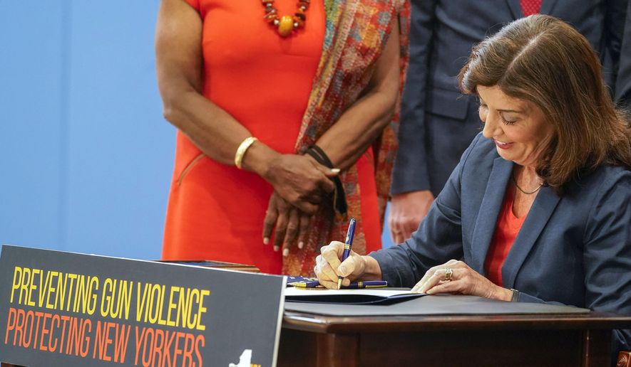 New York Gov. Kathy Hochul signs a package of bills to strengthen gun laws, June 6, 2022, in New York. The Supreme Court, Thursday, June 23, 2022, struck down a restrictive New York gun law in a major ruling for gun rights. (AP Photo/Mary Altaffer, File)