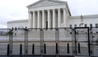 Anti-scaling fencing is seen outside the Supreme Court, Thursday, June 23, 2022, in Washington. On the eve of a ruling on abortion rights, a new Gallup poll shows a historic low in public confidence in the nation&#39;s high court. (AP Photo/Jacquelyn Martin)  **FILE**