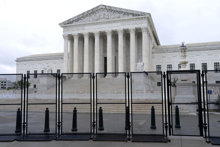 Anti-scaling fencing is seen outside the Supreme Court, Thursday, June 23, 2022, in Washington. On the eve of a ruling on abortion rights, a new Gallup poll shows a historic low in public confidence in the nation's high court. (AP Photo/Jacquelyn Martin) **FILE**