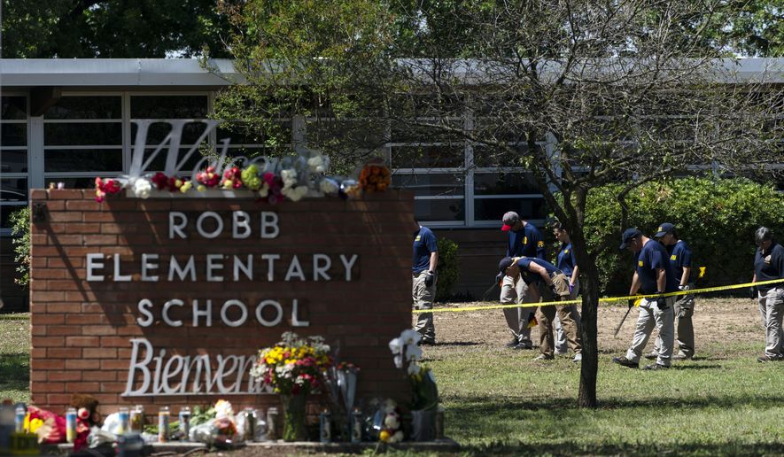 Investigators search for evidence outside Robb Elementary School in Uvalde, Texas, May 25, 2022, after an 18-year-old gunman killed 19 students and two teachers. The district’s superintendent said Wednesday, June 22, that Chief Pete Arredondo, the Uvalde school district’s police chief,  has been put on leave following allegations that he erred in his response to the mass shooting.  (AP Photo/Jae C. Hong, File)