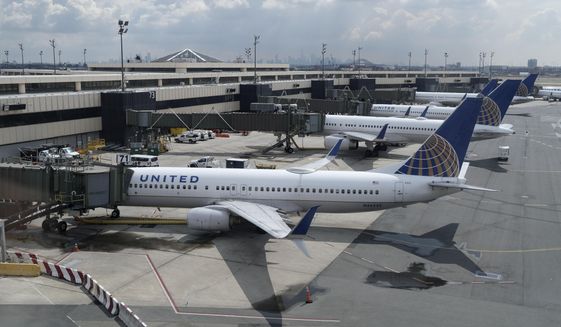 United Airlines planes are parked at gates at Newark Liberty International Airport in Newark, N.J., on July 1, 2020.  United Airlines will cut about 50 flights a day in Newark,   to try to limit flight delays and cancellations there this summer. A United spokeswoman said Thursday, June 23, 2022 that the flights being cut are all domestic, and no destinations are being dropped entirely. (AP Photo/Seth Wenig, File)