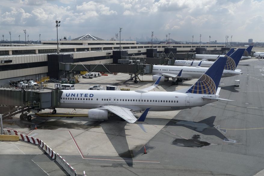 United Airlines planes are parked at gates at Newark Liberty International Airport in Newark, N.J., on July 1, 2020.  United Airlines will cut about 50 flights a day in Newark,   to try to limit flight delays and cancellations there this summer. A United spokeswoman said Thursday, June 23, 2022 that the flights being cut are all domestic, and no destinations are being dropped entirely. (AP Photo/Seth Wenig, File)