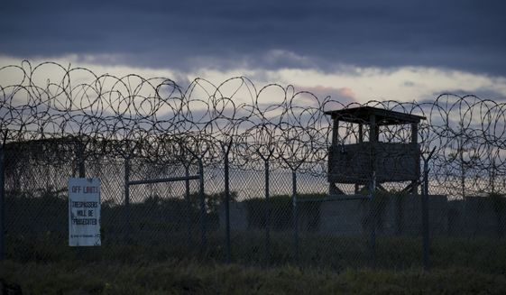 FILE - In this photo reviewed by U.S. military officials, the sun sets behind the closed Camp X-Ray detention facility, Wednesday, April 17, 2019, in Guantanamo Bay Naval Base, Cuba. An Afghan prisoner held in U.S. custody for nearly 15 years has finally been released from the Guantanamo Bay detention center, the Taliban in Afghanistan and an international human rights group said Friday, June 24, 2022.  (AP Photo/Alex Brandon, File)
