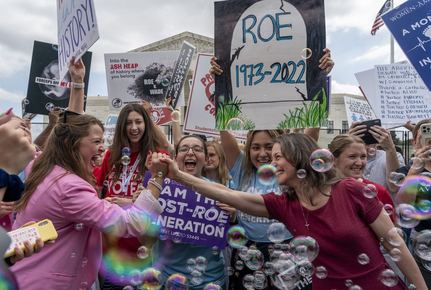 Anti-abortion protesters celebrate following Supreme Court&#x27;s decision to overturn Roe v. Wade, federally protected right to abortion, outside the Supreme Court in Washington, Friday, June 24, 2022. The Supreme Court has ended constitutional protections for abortion that had been in place nearly 50 years, a decision by its conservative majority to overturn the court&#x27;s landmark abortion cases. (AP Photo/Gemunu Amarasinghe)