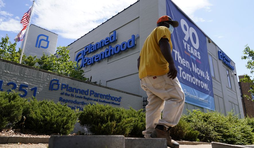 A person walks past Planned Parenthood Friday, June 24, 2022, in St. Louis. Most abortions are now illegal in Missouri following a U.S. Supreme Court decision that ended a constitutional protection for abortion. (AP Photo/Jeff Roberson)