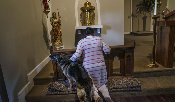 Tanya Britton prays with her dog, Sybil, by her side, while helping to prepare for Mass at St. James Catholic Church in Tupelo, Miss., Tuesday, May 24, 2022. Many people across the U.S. are reacting with horror to the Supreme Court&#39;s abortion decision, overturning Roe v. Wade. But on a day that belonged to the victors, millions of others like Britton, who&#39;ve been immersed in the anti-abortion movement for the past half-century, are rejoicing. (AP Photo/David Goldman)