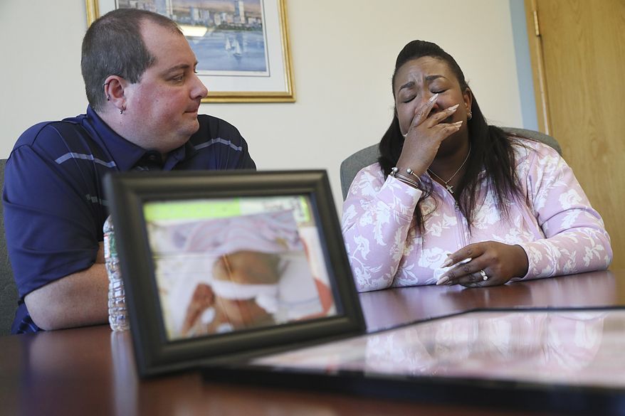 Daniel McCarthy, left, and Alana Ross, parents of premature born baby Everleigh, are interviewed, Monday, June 20, 2022 in Boston. Everleigh, who was born at Brigham and Women&#39;s Hospital in Boston, survived less than two weeks and was accidentally thrown out with dirty linens, according to a lawsuit filed Thursday June 23, 2022. (Suzanne Kreiter/The Boston Globe via AP)