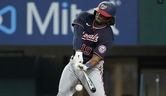Washington Nationals&#39; Josh Bell connects for a run-scoring single in the eighth inning of a baseball game against the Texas Rangers, Friday, June 24, 2022, in Arlington, Texas. Juan Soto scored on the hit. (AP Photo/Tony Gutierrez)