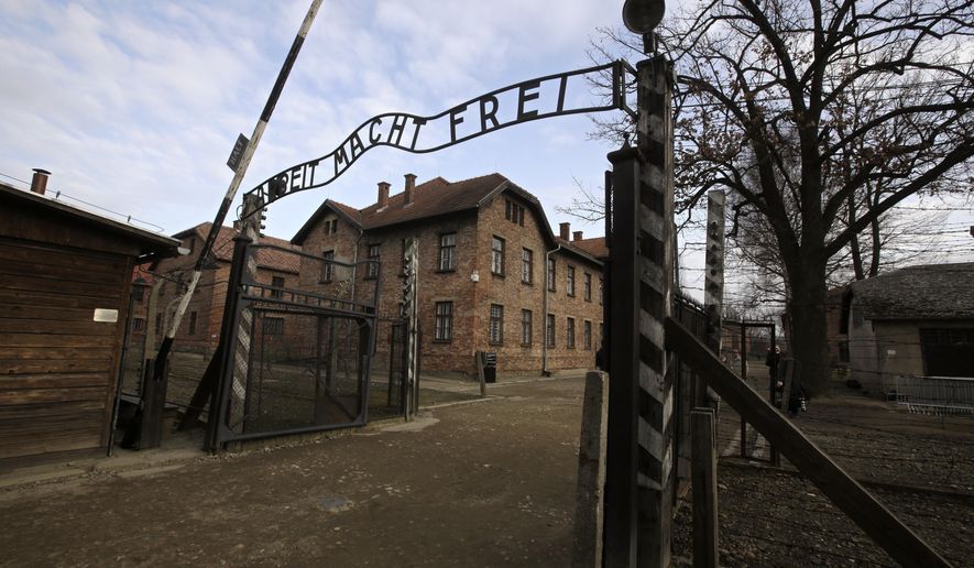FILE - A view of the gate of the Auschwitz Nazi death camp in Oswiecim, Poland, Jan. 27, 2020.  he Auschwitz-Birkenau museum says it has been targeted with the use of “primitive” propaganda after disinformation spread on Russian social media posts. The museum said Friday, June 24, 2022 that fake posts claim to show stickers placed around the memorial site in southern Poland, an area under German occupation during World War II. The stickers say “the only gas the Russians deserve is Zykon B.&amp;quot; (AP Photo/Markus Schreiber, file)