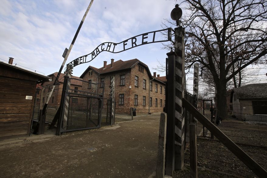 FILE - A view of the gate of the Auschwitz Nazi death camp in Oswiecim, Poland, Jan. 27, 2020.  he Auschwitz-Birkenau museum says it has been targeted with the use of “primitive” propaganda after disinformation spread on Russian social media posts. The museum said Friday, June 24, 2022 that fake posts claim to show stickers placed around the memorial site in southern Poland, an area under German occupation during World War II. The stickers say “the only gas the Russians deserve is Zykon B.&amp;quot; (AP Photo/Markus Schreiber, file)