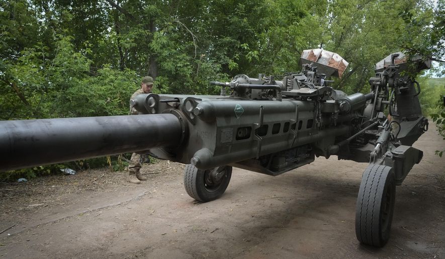 Ukrainian soldiers move a U.S.-supplied M777 howitzer into position to fire at Russian positions in Ukraine&#39;s eastern Donetsk region June 18, 2022. (AP Photo/Efrem Lukatsky, File)