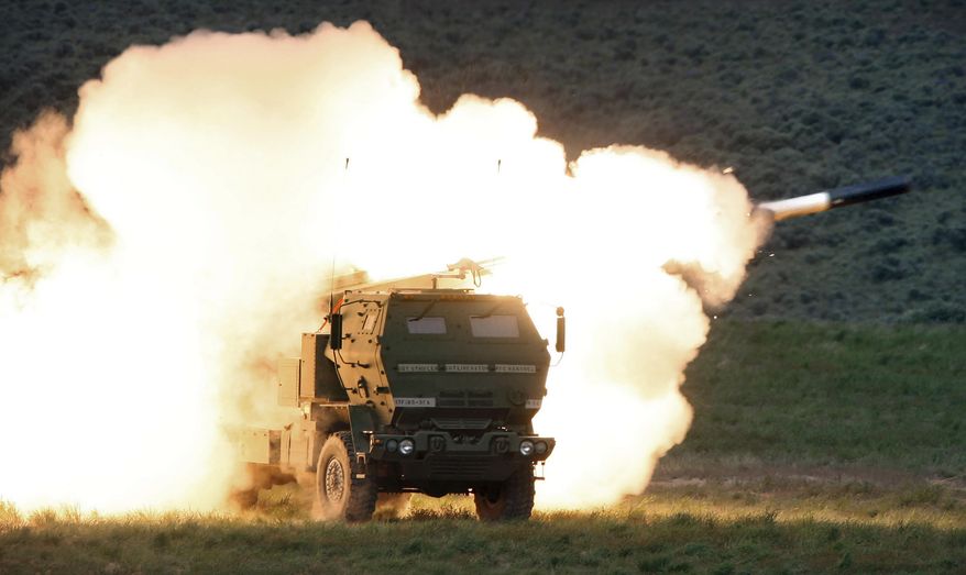 In this May 23, 2011, photo, a launch truck fires the High Mobility Artillery Rocket System (HIMARS) produced by Lockheed Martin during combat training in the high desert of the Yakima Training Center, Wash. U.S. officials will send another $450 million in military aid to Ukraine, including some additional medium-range rocket systems. The latest package will include a number of High Mobility Artillery Rocket Systems, or HIMARS. (Tony Overman/The Olympian via AP) **FILE**