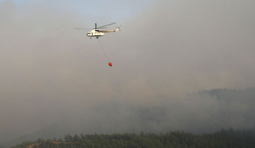A water-dropping aircraft flies over the Bordubet region, near Marmaris, western Turkey, Thursday, June 23, 2022. Water-dropping aircraft from Azerbaijan and Qatar on Friday joined the fight against a wind-stoked wildfire that burned for a fourth day near a popular resort in southwestern Turkey. Turkey&#x27;s forestry minister meanwhile, said the fire may be close to being contained but said the wind still posed a risk. (AP Photo)