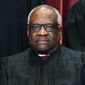 Associate Justice Clarence Thomas sits during a group photo at the Supreme Court in Washington, Friday, April 23, 2021. The Supreme Court&#39;s sweeping rulings on guns and abortion were the latest and perhaps clearest manifestation of how the court has evolved over the past six years, a product of historical accident and Republican political brute force, from an institution that leaned right, but produced some notable liberal victories, to one with an aggressive, 6-3 conservative majority. (Erin Schaff/The New York Times via AP, Pool)
