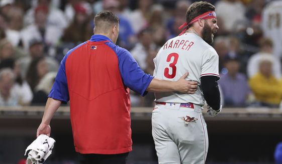 Philadelphia Phillies&#39; Bryce Harper, right, reacts towards San Diego Padres&#39; Blake Snell after being hit by a pitch from Snell, as he walks off the field with a trainer during the fourth inning of a baseball game Saturday, June 25, 2022, in San Diego. (AP Photo/Derrick Tuskan)