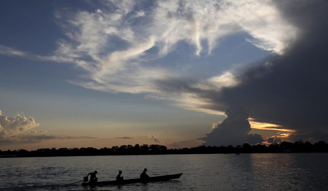 FILE - Local residents navigate the Amazon River near Leticia, Colombia, Sept. 7, 2019. Gustavo Petro, Colombia&#x27;s first elected leftist president, will take office in August with ambitious proposals to halt the record-high rates of deforestation in the Amazon. (AP Photo/Fernando Vergara, File)