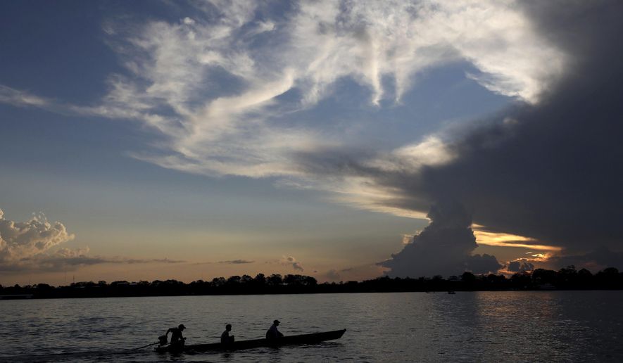 FILE - Local residents navigate the Amazon River near Leticia, Colombia, Sept. 7, 2019. Gustavo Petro, Colombia&#39;s first elected leftist president, will take office in August with ambitious proposals to halt the record-high rates of deforestation in the Amazon. (AP Photo/Fernando Vergara, File)