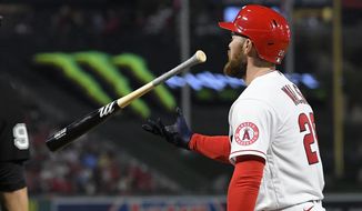 Los Angeles Angels&#x27; Jared Walsh flips his bat after striking out during the sixth inning of a baseball game against the Seattle Mariners Friday, June 24, 2022, in Anaheim, Calif. (AP Photo/Mark J. Terrill)