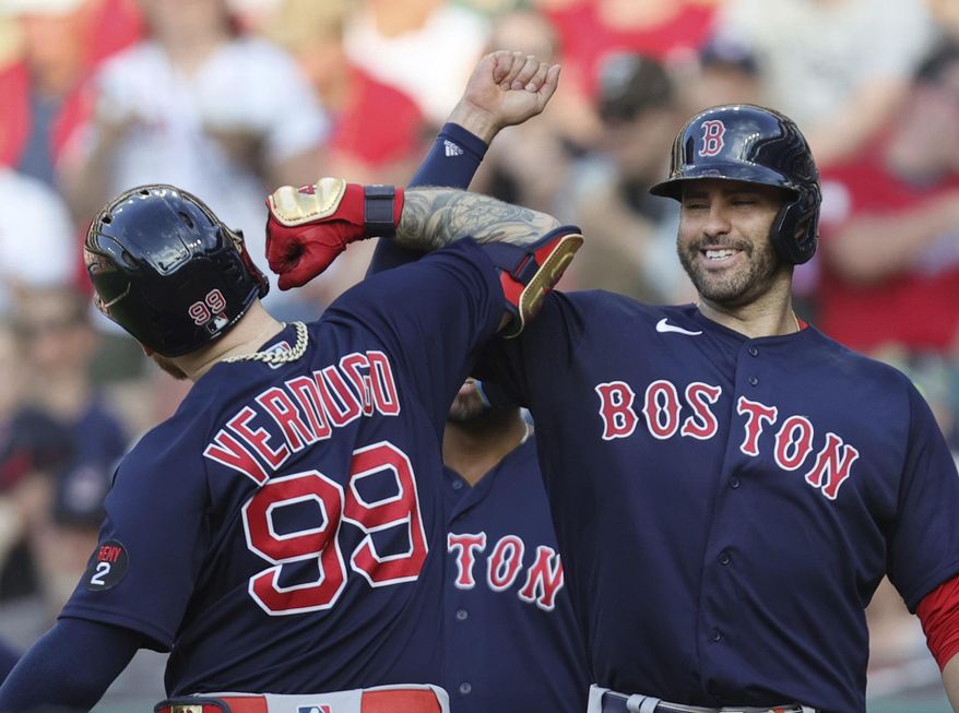 Boston Red Sox&#39;s J.D. Martinez, right, celebrates a three-run home run by Alex Verdugo (99) against the Cleveland Guardians during the sixth inning of a baseball game Saturday, June 25, 2022, in Cleveland. (John Kuntz/Cleveland.com via AP)