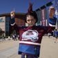 Ten-year-old Greyson Goldstein stands outside Ball Arena before Game 1 of the NHL hockey Stanley Cup Final between the Tampa Bay Lightning and the Colorado Avalanche Wednesday, June 15, 2022, in Denver. (AP Photo/David Zalubowski)