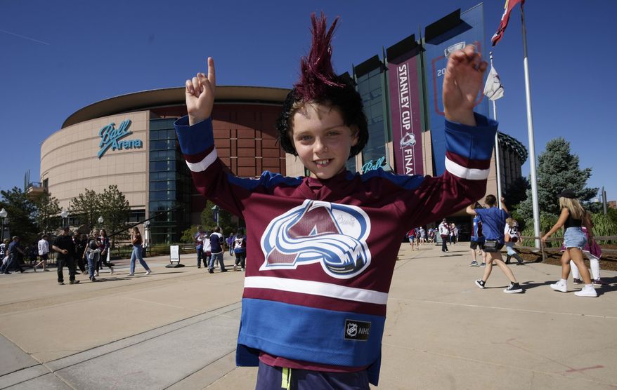 Ten-year-old Greyson Goldstein stands outside Ball Arena before Game 1 of the NHL hockey Stanley Cup Final between the Tampa Bay Lightning and the Colorado Avalanche Wednesday, June 15, 2022, in Denver. (AP Photo/David Zalubowski)