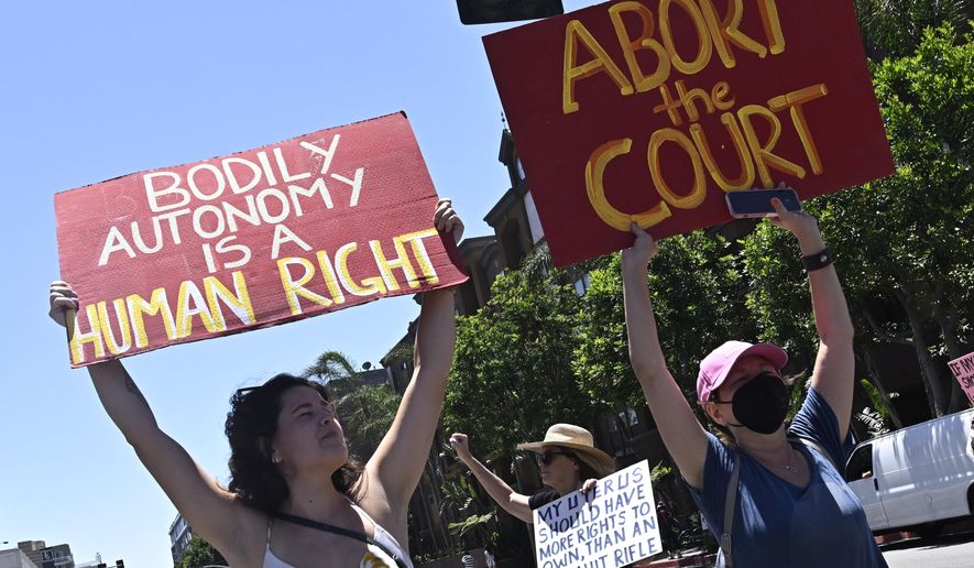 Activists march through downtown Los Angeles, Saturday, June 25, 2022, as they protest the Supreme Court's ruling on abortion. (Keith Birmingham/The Orange County Register via AP)