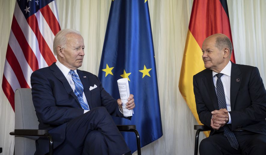 German Chancellor Olaf Scholz, right, welcomes US President Joe Biden, left, for a bilateral meeting at Castle Elmau in Kruen, near Garmisch-Partenkirchen, Germany, on Sunday, June 26, 2022. The Group of Seven leading economic powers are meeting in Germany for their annual gathering Sunday through Tuesday. (Michael Kappeler/dpa via AP)