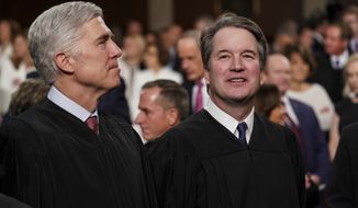 In this Feb. 5, 2019 file photo, Supreme Court Associate Justices Neil Gorsuch, left, and Brett Kavanaugh watch as President Donald Trump arrives to give his State of the Union address to a joint session on Congress at the Capitol in Washington. The Supreme Court&#x27;s decision that women have no constitutional right to an abortion marked the apex of a week that reinforced Donald Trump&#x27;s grip on Washington more than a year and a half after he exited the White House for the final time. The same Supreme Court now dominated by Trump-appointed conservatives also voted to weaken restrictions on gun ownership. (Doug Mills/The New York Times via AP, Pool) **FILE**