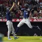 Seattle Mariners&#39; Julio Rodriguez, right, celebrates with J.P. Crawford after they scored on a single by Kevin Padlo during the sixth inning of a baseball game Saturday, June 25, 2022, in Anaheim, Calif. (AP Photo/Mark J. Terrill)